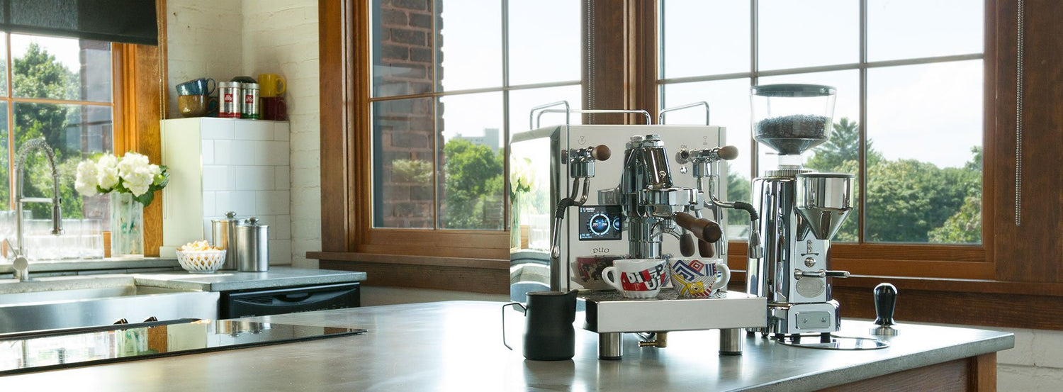 A Bezzera espresso machine on a kitchen counter in front of a large window