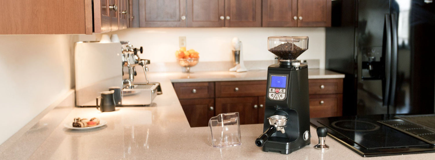 A Eureka coffee and espresso grinder on a kitchen counter.
