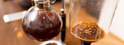 A Yama vacuum siphon coffee maker brewing coffee.