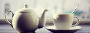 A white Teaposy set with a white kettle and coffee cup and saucer set.