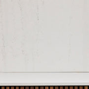 White wall with a wooden baseboard.
