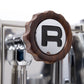 Steam knob with wood accent, emblazoned with Rocket Espresso's "R"